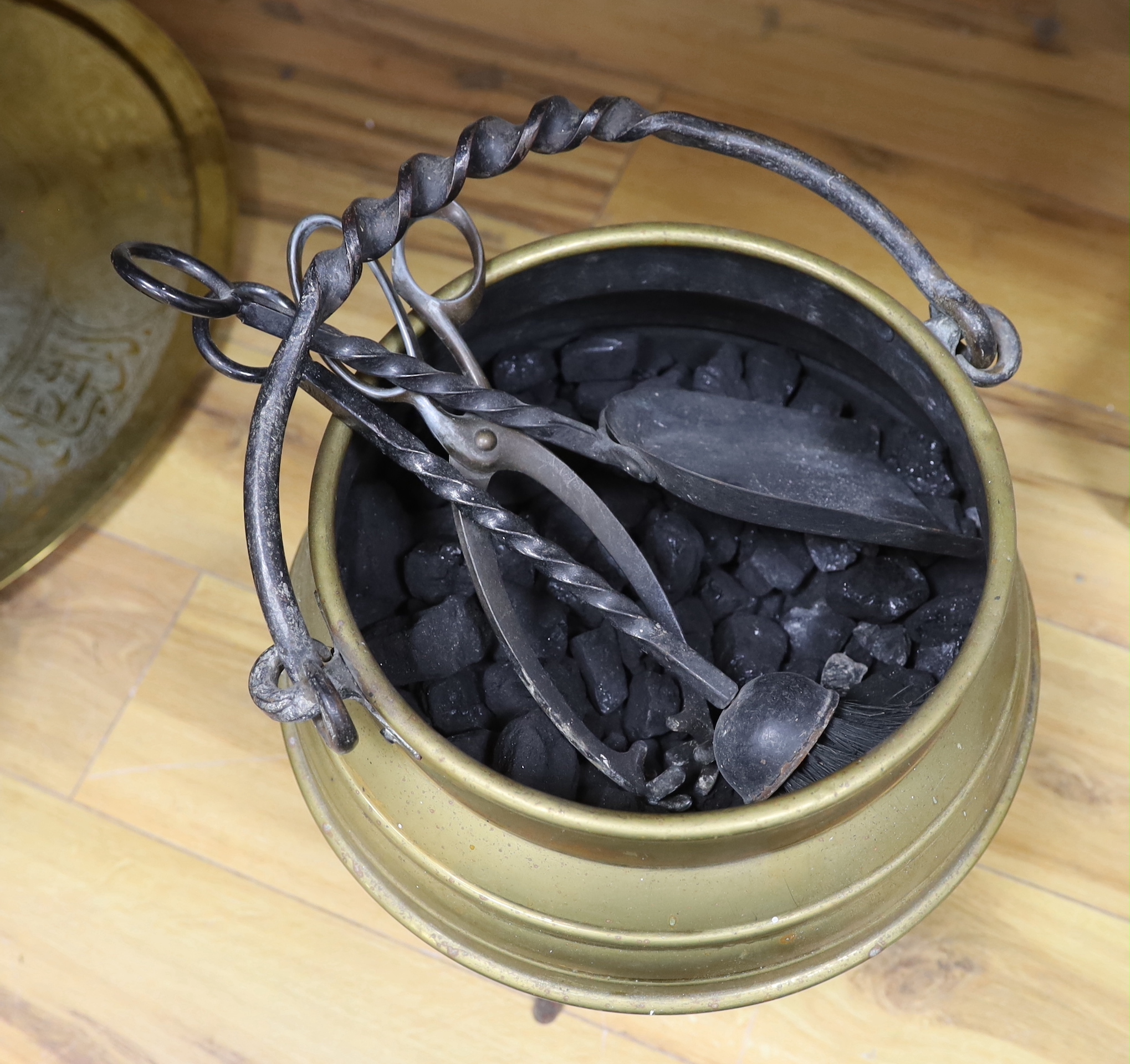 A brass cauldron shaped coal scuttle, a large circular tray, two kettles, a jug and a vase, tray 65cm diameter